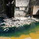 Women walk past tannery wastewater that is being pumped from a factory straight into the street of the Ain el Sirra district of Cairo June 14, 2007. Many people walk barefoot through the this district, seemingly not bothered by the waste, odours of chemicals and the smell of unprocessed skins. REUTERS/Steve Crisp (EGYPT) - GM1DVMFLURAA